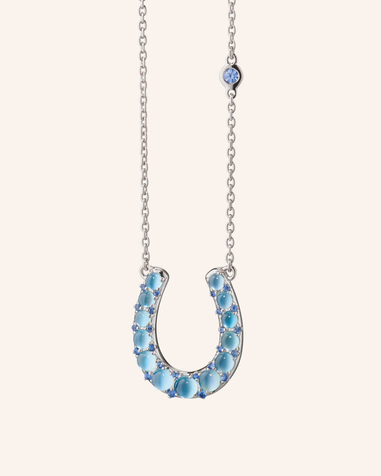 The Horseshoe Necklace with Blue Topaz Over Mother of Pearl