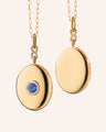 18k yellow gold infinity locket with center blue sapphire