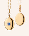 18k yellow gold infinity locket with center blue sapphire