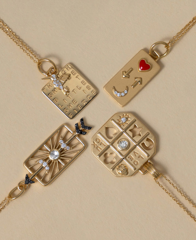 She is Fierce, Love you to the moon and back, Tokens of Luck and Love, and Shoot for the moon charm necklaces in 18k gold with diamonds. 