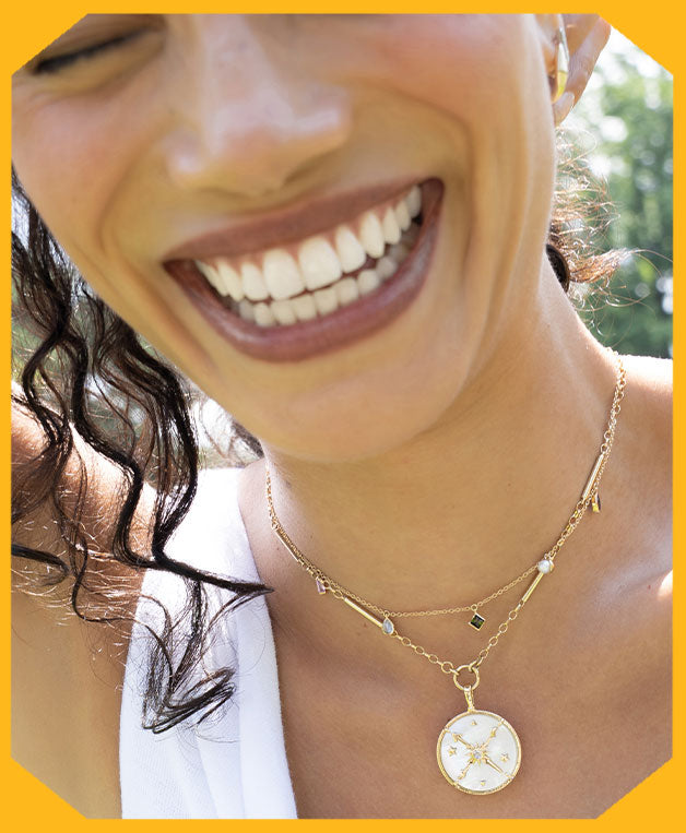 Woman wearing 18k Gold necklaces featuring a 