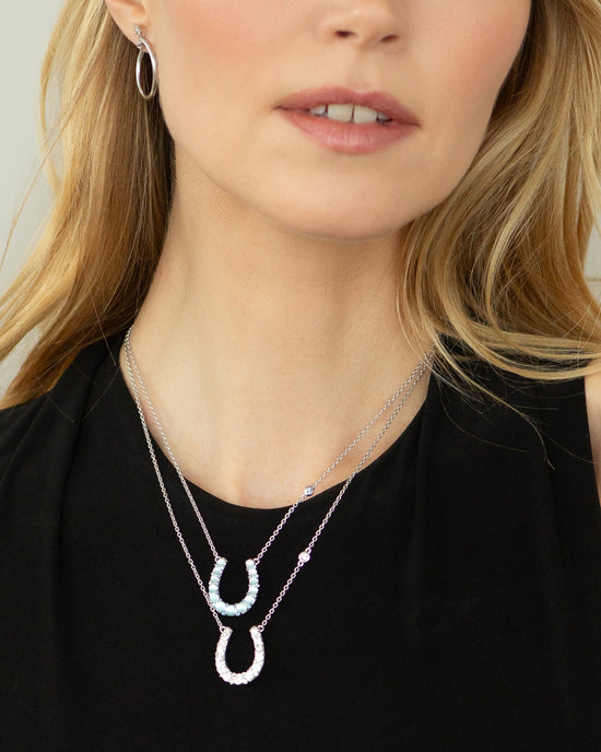 The Horseshoe Necklace with Blue Topaz Over Mother of Pearl